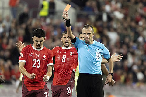 2024–25 UEFA Nations League, Switzerland vs Spain: Referee Irfan Peljto shows the red card to Spain's defender Robin Le Normand